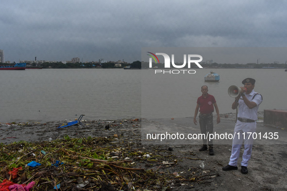 Police officials patrol a riverside in Kolkata, India, on October 24, 2024, as a precautionary measure ahead of the landfall of Cyclone Dana...