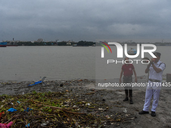 Police officials patrol a riverside in Kolkata, India, on October 24, 2024, as a precautionary measure ahead of the landfall of Cyclone Dana...