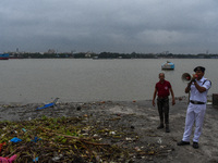 Police officials patrol a riverside in Kolkata, India, on October 24, 2024, as a precautionary measure ahead of the landfall of Cyclone Dana...