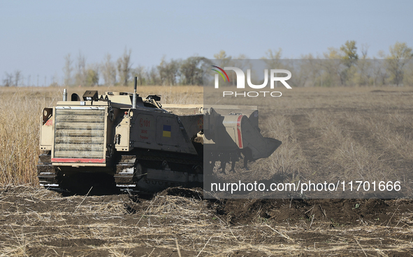 A specialized vehicle is seen during the humanitarian demining using the latest remote control equipment in the Kharkiv region, Ukraine, on...