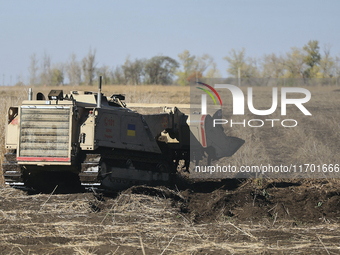 A specialized vehicle is seen during the humanitarian demining using the latest remote control equipment in the Kharkiv region, Ukraine, on...