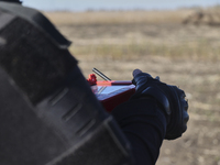 A rescuer holds a remote control during humanitarian demining using the latest devices in the Kharkiv region, Ukraine, on October 23, 2024....