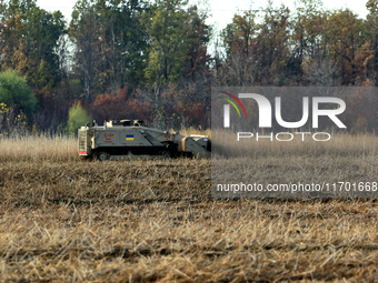 A specialized vehicle is seen during the humanitarian demining using the latest remote control equipment in the Kharkiv region, Ukraine, on...