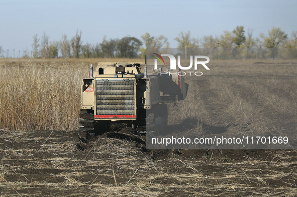 A specialized vehicle is seen during the humanitarian demining using the latest remote control equipment in the Kharkiv region, Ukraine, on...