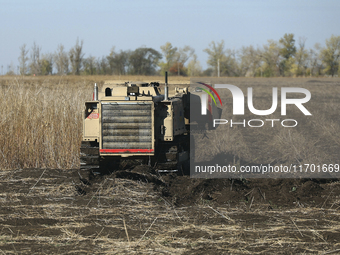 A specialized vehicle is seen during the humanitarian demining using the latest remote control equipment in the Kharkiv region, Ukraine, on...