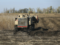 A specialized vehicle is seen during the humanitarian demining using the latest remote control equipment in the Kharkiv region, Ukraine, on...