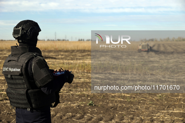 A rescuer works on humanitarian demining using the latest remote control equipment in the Kharkiv region, Ukraine, on October 23, 2024. 