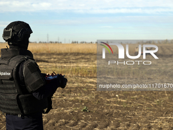 A rescuer works on humanitarian demining using the latest remote control equipment in the Kharkiv region, Ukraine, on October 23, 2024. (