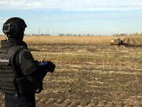 A rescuer works on humanitarian demining using the latest remote control equipment in the Kharkiv region, Ukraine, on October 23, 2024. (