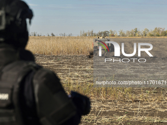 A rescuer works on humanitarian demining using the latest remote control equipment in the Kharkiv region, Ukraine, on October 23, 2024. (