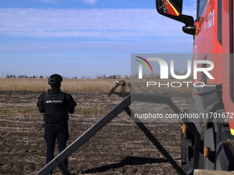 A rescuer works on humanitarian demining using the latest remote control equipment in the Kharkiv region, Ukraine, on October 23, 2024. (