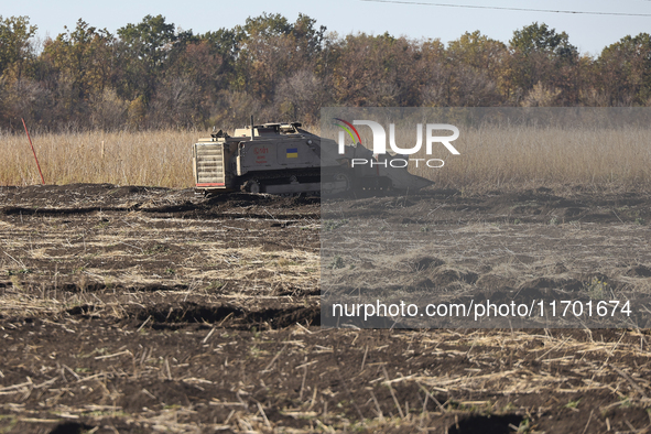 A specialized vehicle is seen during the humanitarian demining using the latest remote control equipment in the Kharkiv region, Ukraine, on...