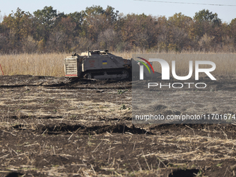 A specialized vehicle is seen during the humanitarian demining using the latest remote control equipment in the Kharkiv region, Ukraine, on...