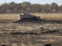 A specialized vehicle is seen during the humanitarian demining using the latest remote control equipment in the Kharkiv region, Ukraine, on...