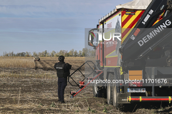 A rescuer works on humanitarian demining using the latest remote control equipment in the Kharkiv region, Ukraine, on October 23, 2024. 