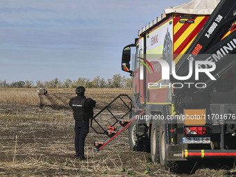 A rescuer works on humanitarian demining using the latest remote control equipment in the Kharkiv region, Ukraine, on October 23, 2024. (