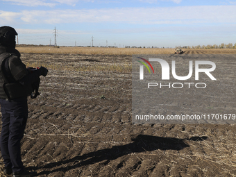 A rescuer works on humanitarian demining using the latest remote control equipment in the Kharkiv region, Ukraine, on October 23, 2024. (