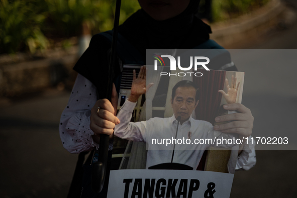 Human rights activists display posters during the 837th Aksi Kamisan, or Thursday's Protest, in front of the Merdeka Palace in Jakarta, Indo...