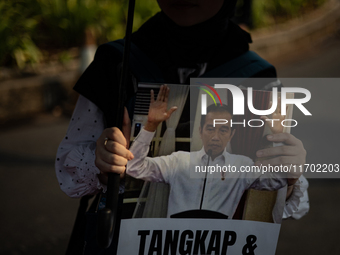 Human rights activists display posters during the 837th Aksi Kamisan, or Thursday's Protest, in front of the Merdeka Palace in Jakarta, Indo...