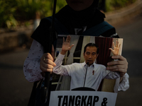 Human rights activists display posters during the 837th Aksi Kamisan, or Thursday's Protest, in front of the Merdeka Palace in Jakarta, Indo...