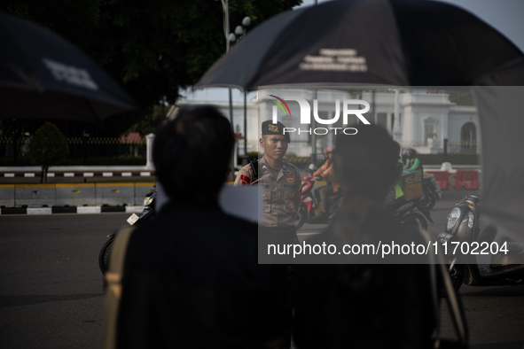 Police guard the 837th Aksi Kamisan, or Thursday's Protest, in front of the Merdeka Palace in Jakarta, Indonesia, on October 24, 2024. This...