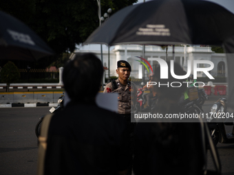 Police guard the 837th Aksi Kamisan, or Thursday's Protest, in front of the Merdeka Palace in Jakarta, Indonesia, on October 24, 2024. This...