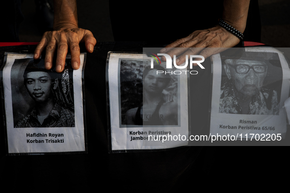 Human rights activists display posters during the 837th Aksi Kamisan, or Thursday's Protest, in front of the Merdeka Palace in Jakarta, Indo...