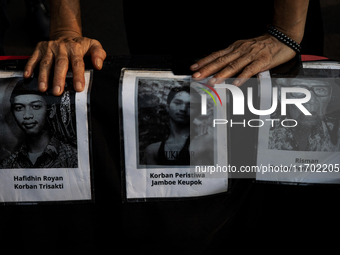 Human rights activists display posters during the 837th Aksi Kamisan, or Thursday's Protest, in front of the Merdeka Palace in Jakarta, Indo...