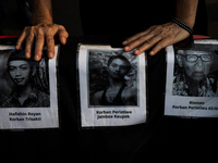 Human rights activists display posters during the 837th Aksi Kamisan, or Thursday's Protest, in front of the Merdeka Palace in Jakarta, Indo...