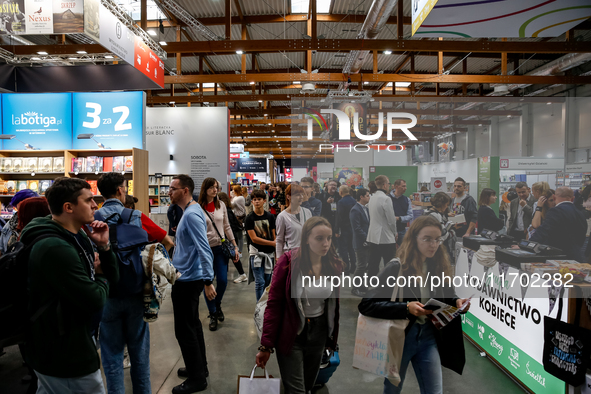 Participants browse on a book stand during the 27. International Book Fair in The International Exhibition and Convention Centre EXPO in Kra...