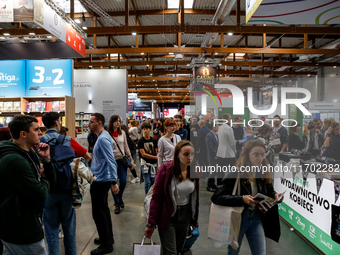 Participants browse on a book stand during the 27. International Book Fair in The International Exhibition and Convention Centre EXPO in Kra...