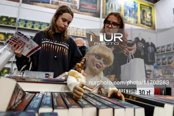 Young adults browse on a book stand during the 27. International Book Fair in The International Exhibition and Convention Centre EXPO in Kra...