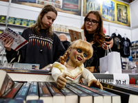 Young adults browse on a book stand during the 27. International Book Fair in The International Exhibition and Convention Centre EXPO in Kra...