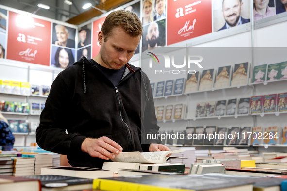 A participant browse on a book stand during the 27. International Book Fair in The International Exhibition and Convention Centre EXPO in Kr...