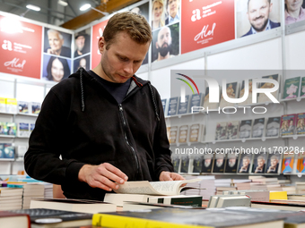 A participant browse on a book stand during the 27. International Book Fair in The International Exhibition and Convention Centre EXPO in Kr...