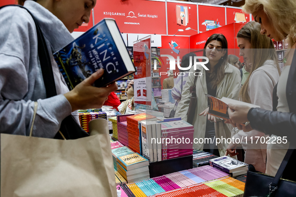 Participants browse on a book stand during the 27. International Book Fair in The International Exhibition and Convention Centre EXPO in Kra...