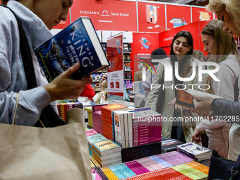 Participants browse on a book stand during the 27. International Book Fair in The International Exhibition and Convention Centre EXPO in Kra...