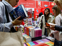 Participants browse on a book stand during the 27. International Book Fair in The International Exhibition and Convention Centre EXPO in Kra...