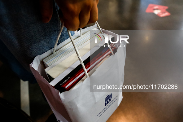 Participants holds a bag with books during the 27. International Book Fair in The International Exhibition and Convention Centre EXPO in Kra...