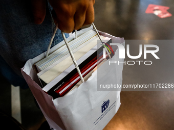 Participants holds a bag with books during the 27. International Book Fair in The International Exhibition and Convention Centre EXPO in Kra...