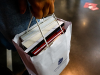 Participants holds a bag with books during the 27. International Book Fair in The International Exhibition and Convention Centre EXPO in Kra...