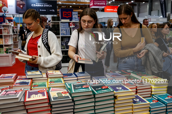 Participants browse on a book stand during the 27. International Book Fair in The International Exhibition and Convention Centre EXPO in Kra...