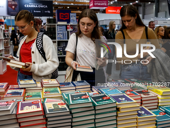 Participants browse on a book stand during the 27. International Book Fair in The International Exhibition and Convention Centre EXPO in Kra...