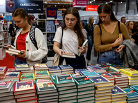 Participants browse on a book stand during the 27. International Book Fair in The International Exhibition and Convention Centre EXPO in Kra...