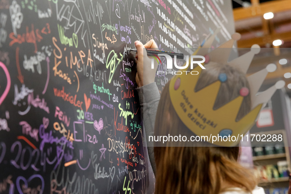 Young adult leaves her signature during the 27. International Book Fair in The International Exhibition and Convention Centre EXPO in Krakow...