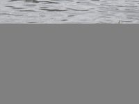 Boatmen wait for passengers at the river Buriganga during rain in Dhaka, Bangladesh, on October 24, 2024. Light rain and wind from Cyclone D...