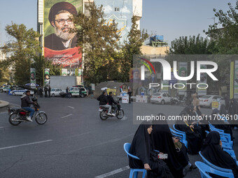 A giant banner features a portrait of Lebanon's Hezbollah Secretary General, Hashem Safieddine, who is killed in an Israeli airstrike, durin...