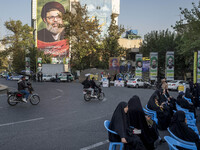 A giant banner features a portrait of Lebanon's Hezbollah Secretary General, Hashem Safieddine, who is killed in an Israeli airstrike, durin...