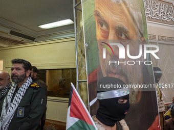 Hassan Hassanzadeh, second from the left, commander in the Islamic Revolutionary Guard Corps (IRGC) in Tehran, stands next to a banner featu...