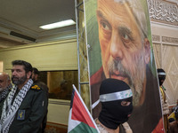 Hassan Hassanzadeh, second from the left, commander in the Islamic Revolutionary Guard Corps (IRGC) in Tehran, stands next to a banner featu...